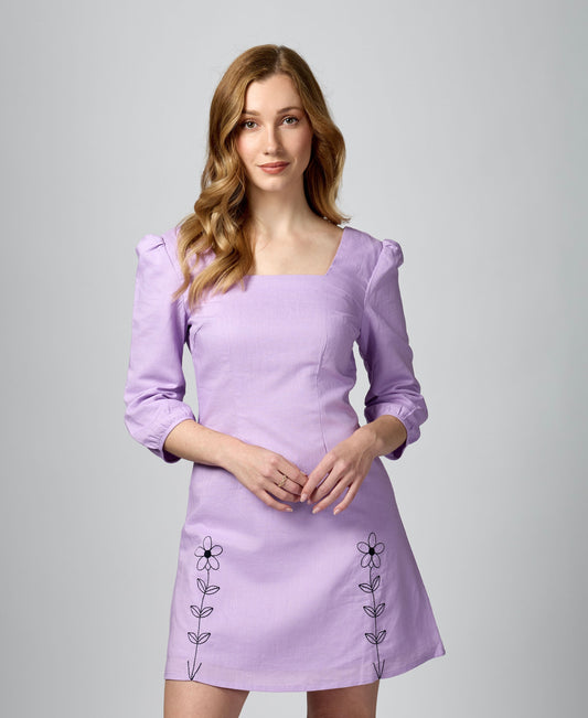 Three-quarter view of lilac 3/4 sleeve mini dress with square neck and 100% combed cotton lining.