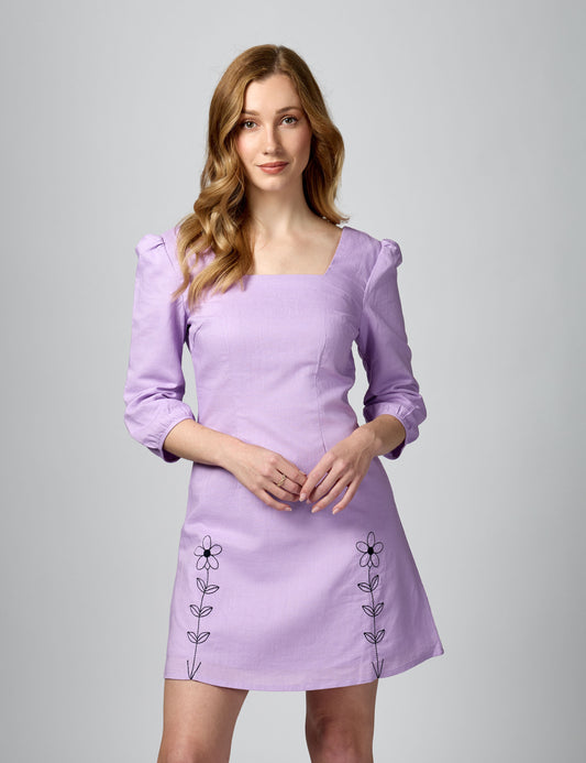 Three-quarter view of lilac 3/4 sleeve mini dress with square neck and 100% combed cotton lining.