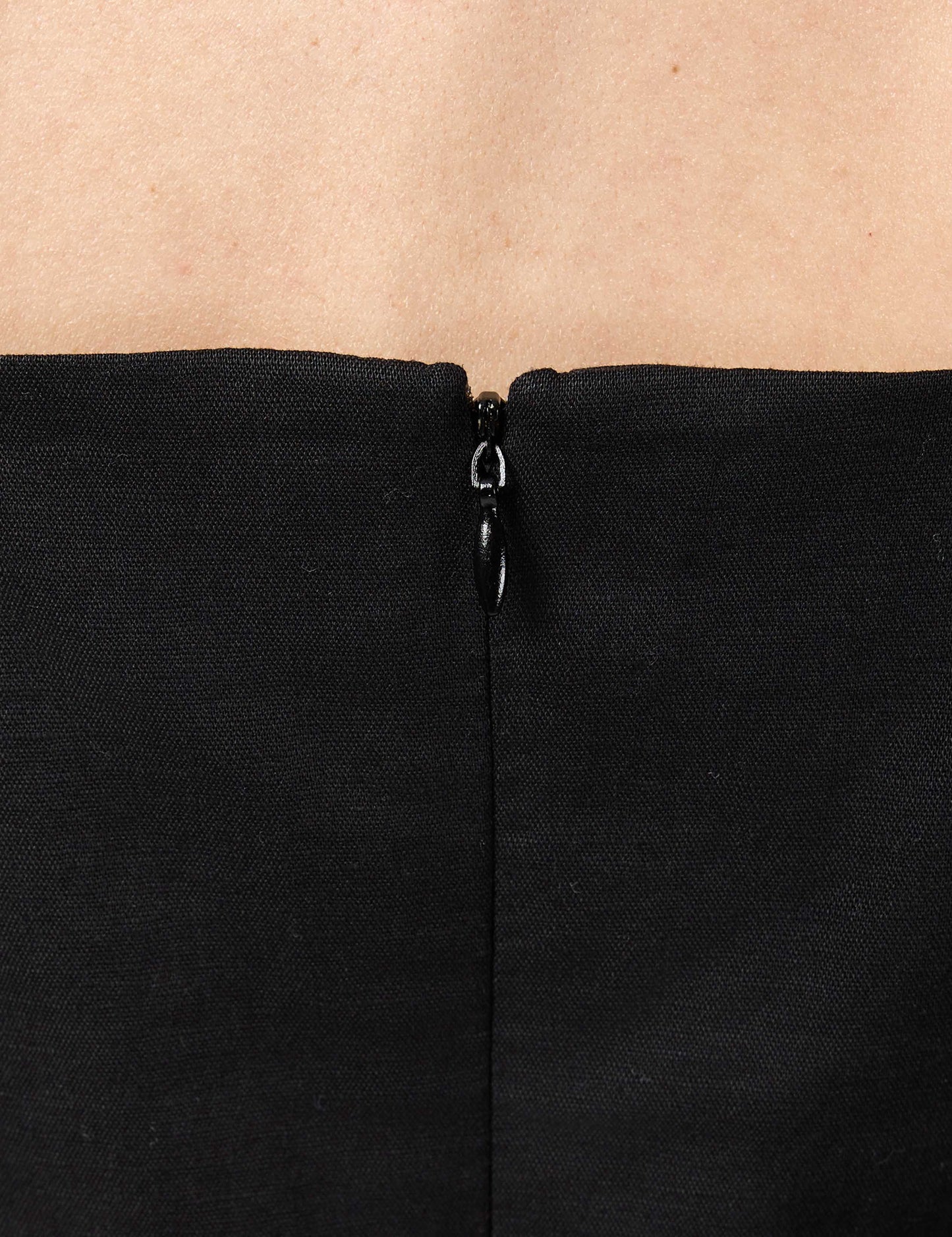 High-quality YKK invisible zip enclosure on the back of a black luxury sustainable linen-cotton dress.