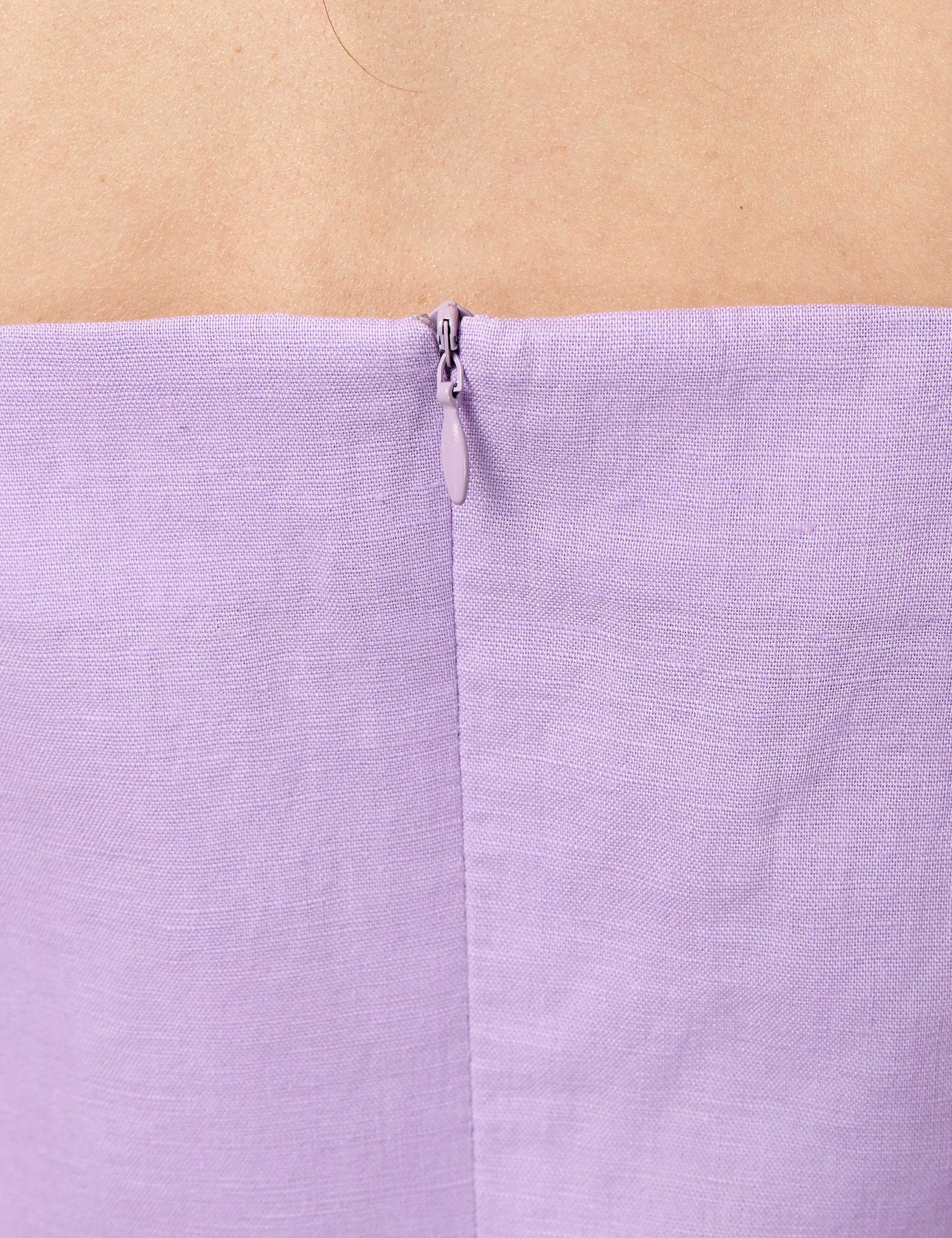 Detail of premium YKK invisible zip on a lilac sustainable dress, ensuring a seamless luxury finish.