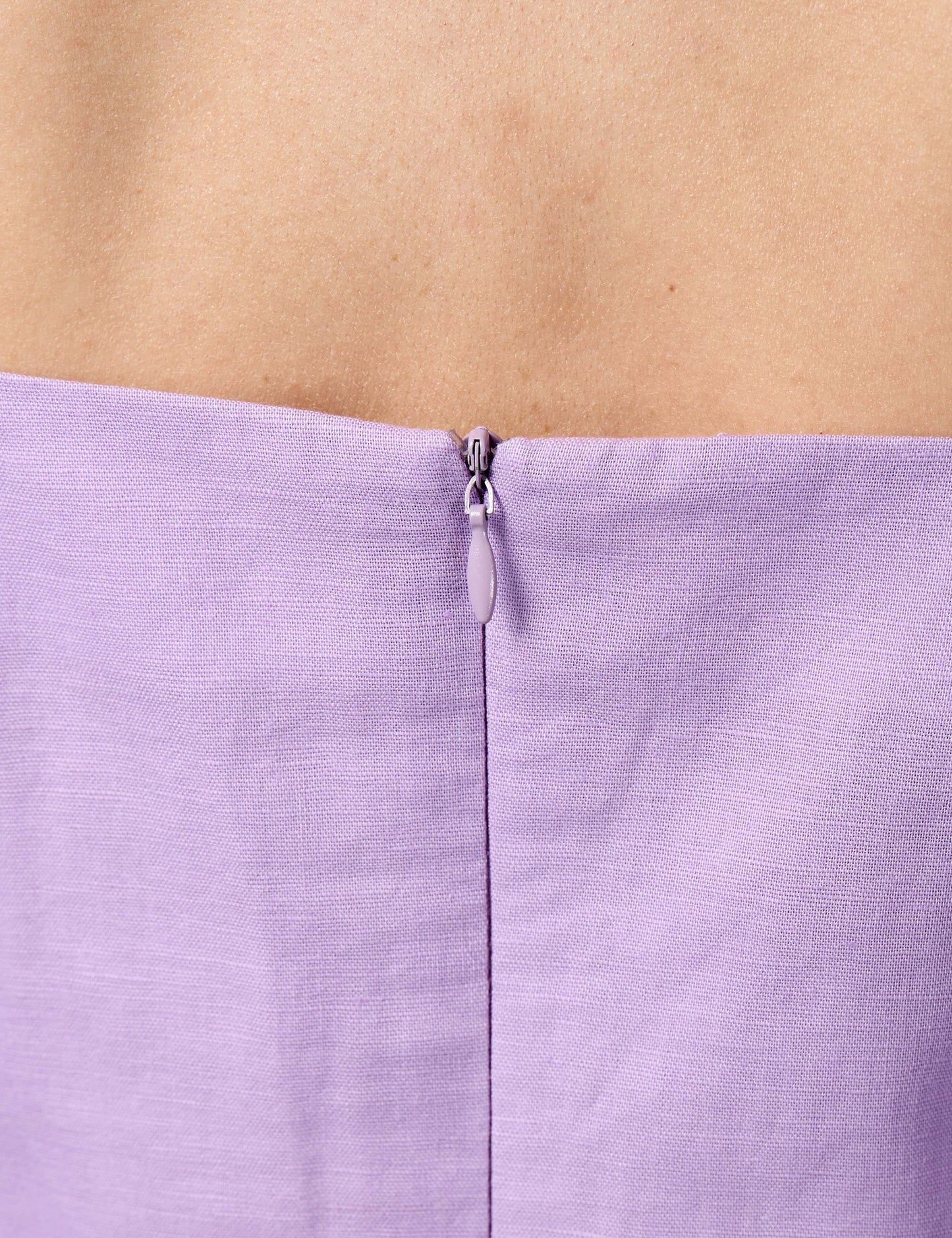 Detail of premium YKK invisible zip on a lilac 3/4 sleeve dress for a seamless luxury finish.